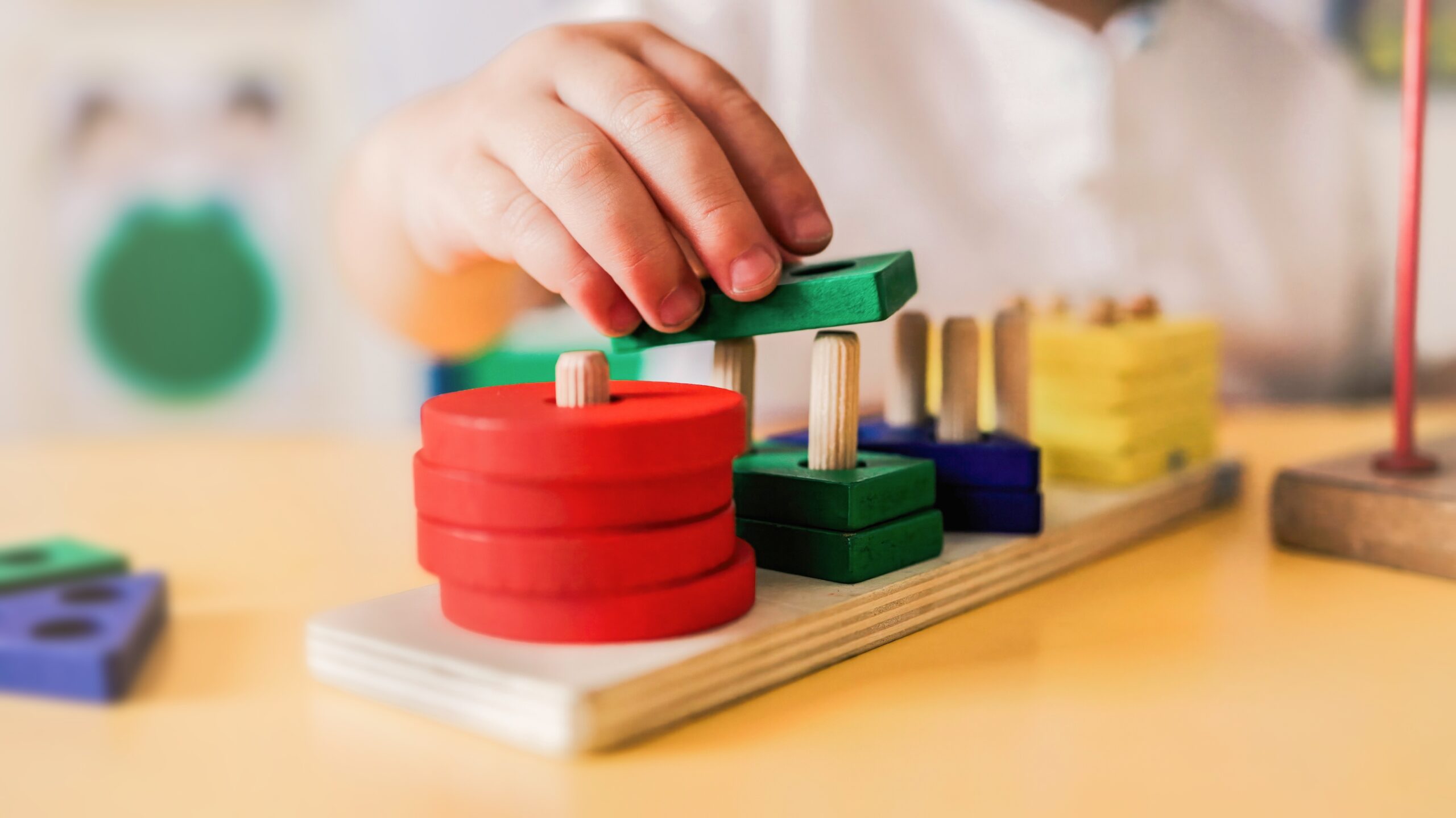 kid,playing,with,wood,toys,at,pre,school,classroom.,kindergarten